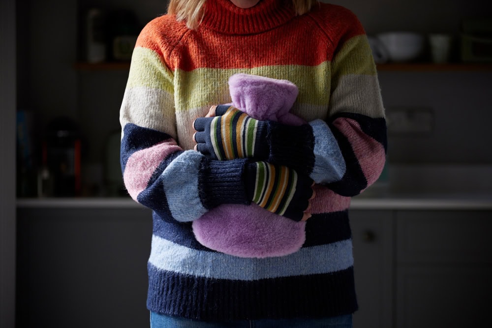 girl shivering in cold home without heat on finding out when the best time to turn it on is