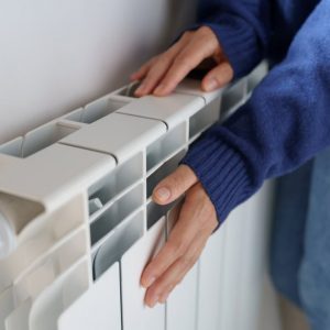 Closeup,Of,Woman,Warming,Her,Hands,On,The,Heater,At