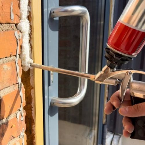 professional using caulk and foam for air sealing home and improving the insulation and air quality for those living inside