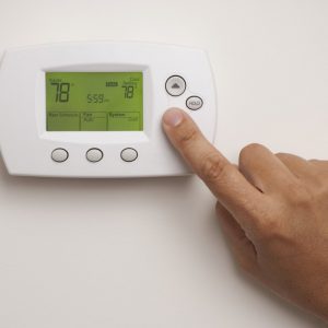 Digital,Thermostat,With,A,Male,Hand,,Set,To,78,Degrees